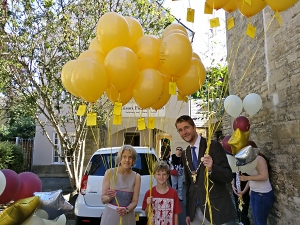 Alison Fielden, Mark Harris and his son prepare to release 30 balloons to celebrate Alison Fielden & Co.'s 30th anniversary