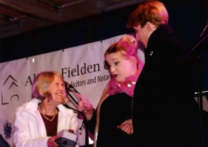 Alison Fielden holds the button as Daisy Cooper and Charlie Cooper prepare to switch on Cirencester's Christmas Lights